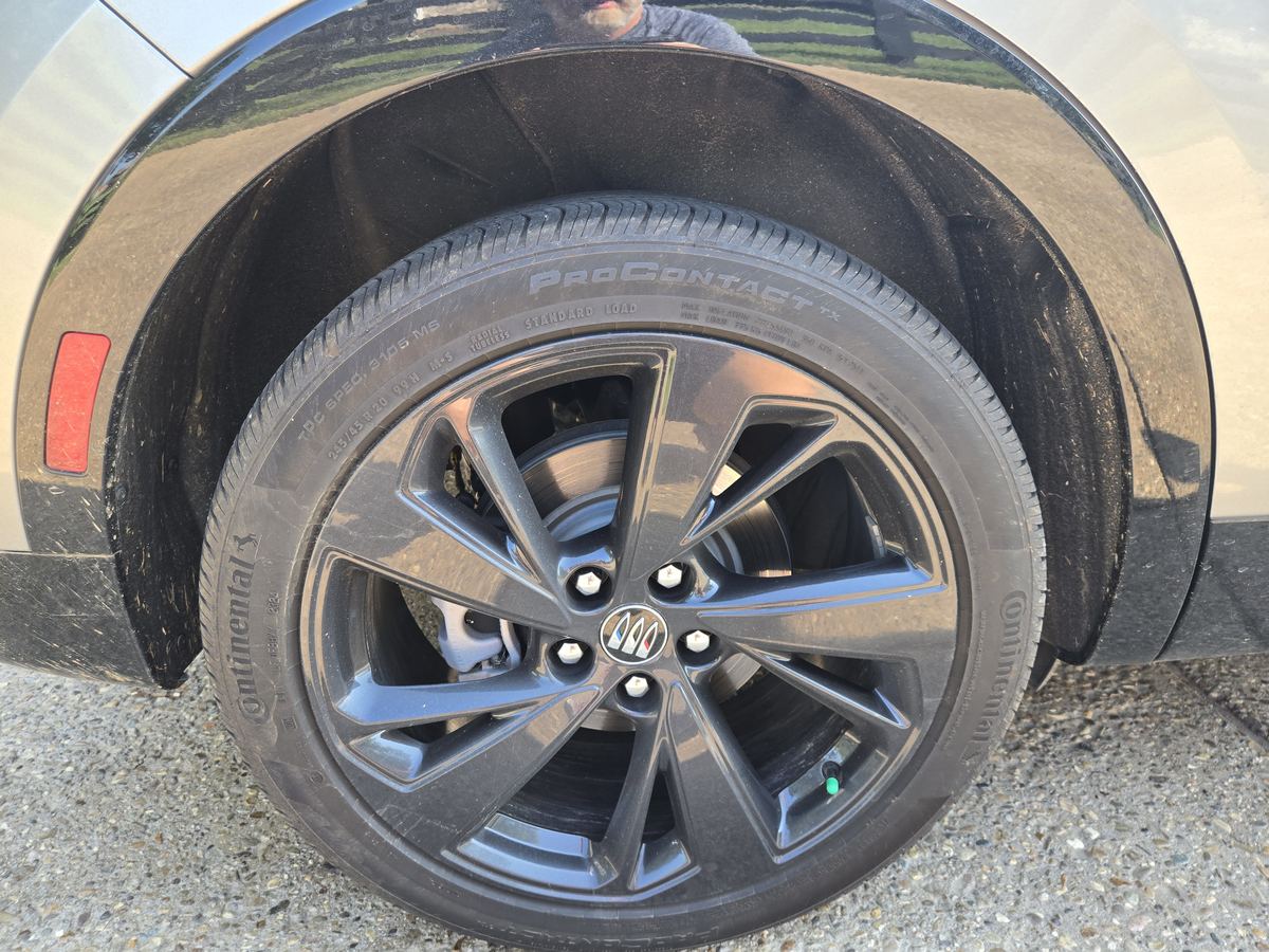 Black wheel covered in brake dust before detailing