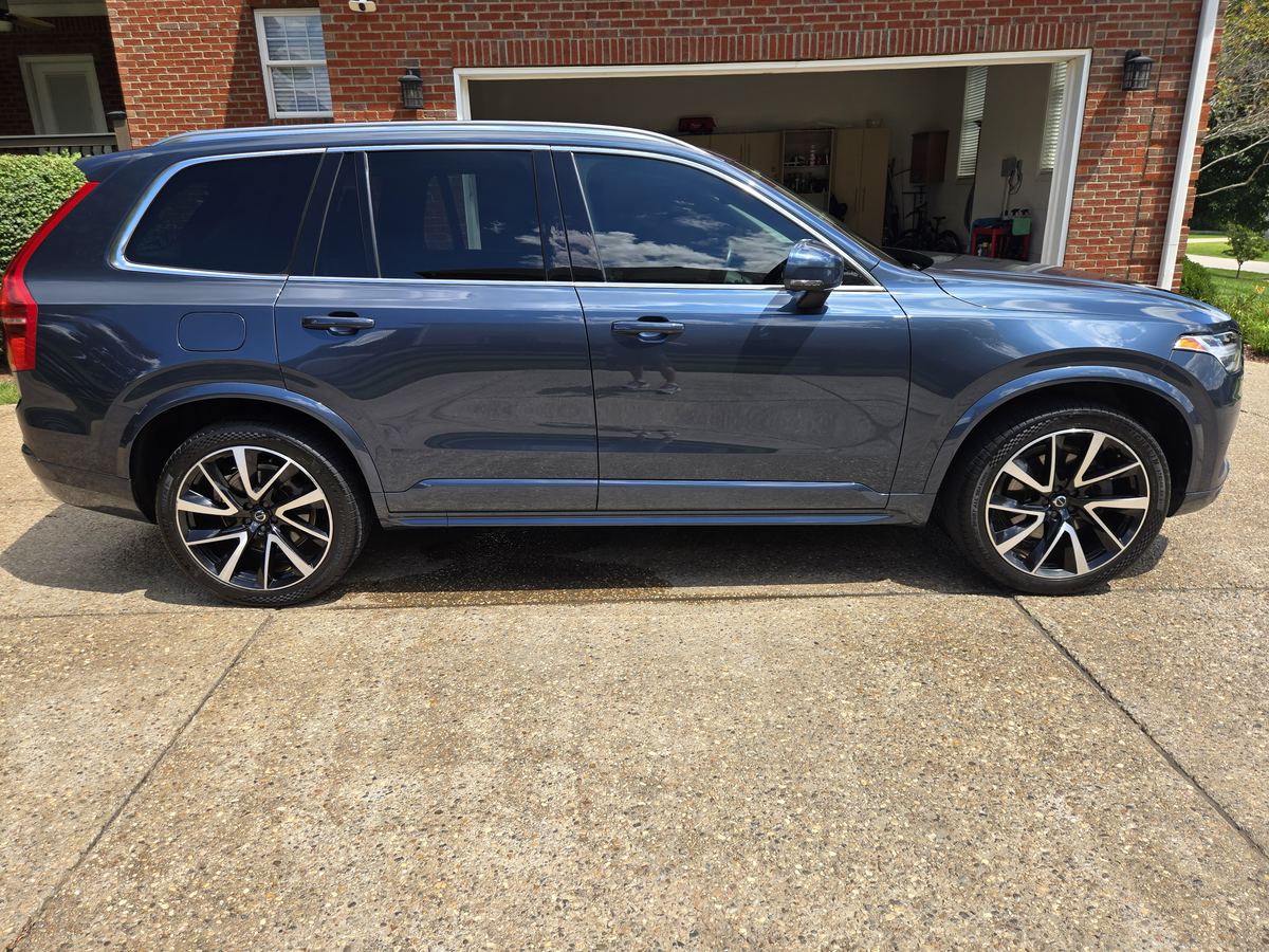 Side view of a detailed dark blue Volvo SUV with glossy paint