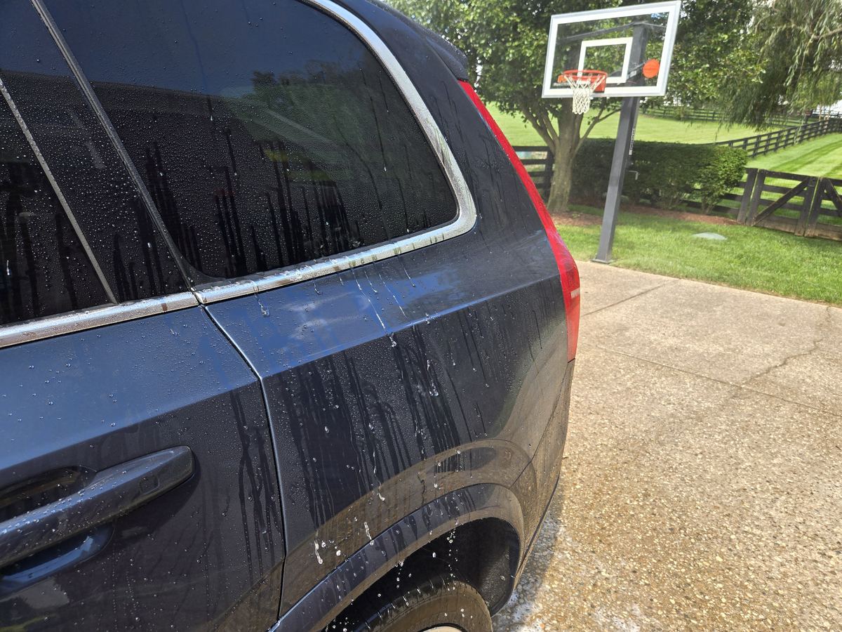 Sealed paint on the rear door of a dark blue SUV