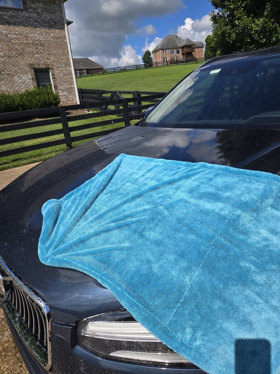 Microfiber drying towel on the hood during a paint sealant service